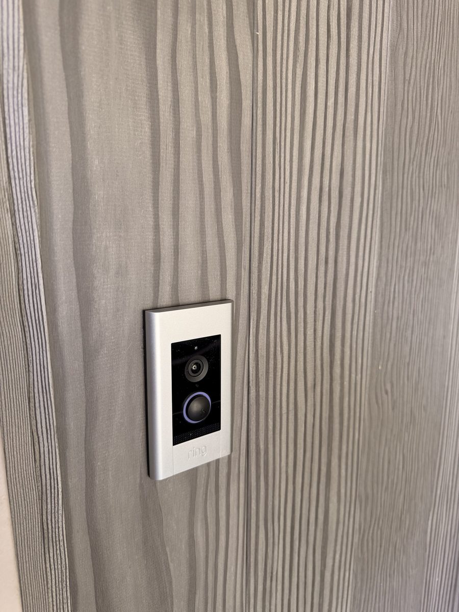 Ring video doorbell newly installed on gray siding