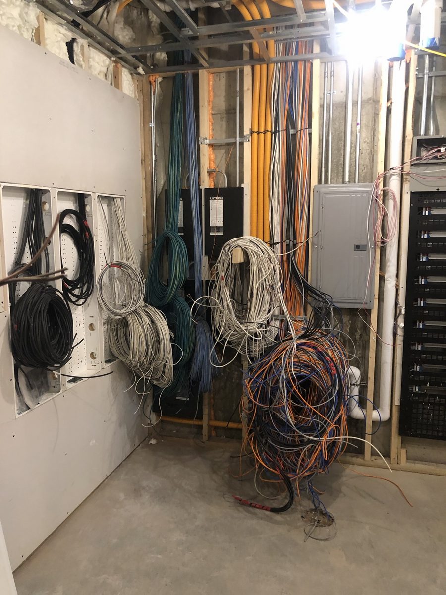 Equipment room wiring rough-in with bundled cables, panels and rack