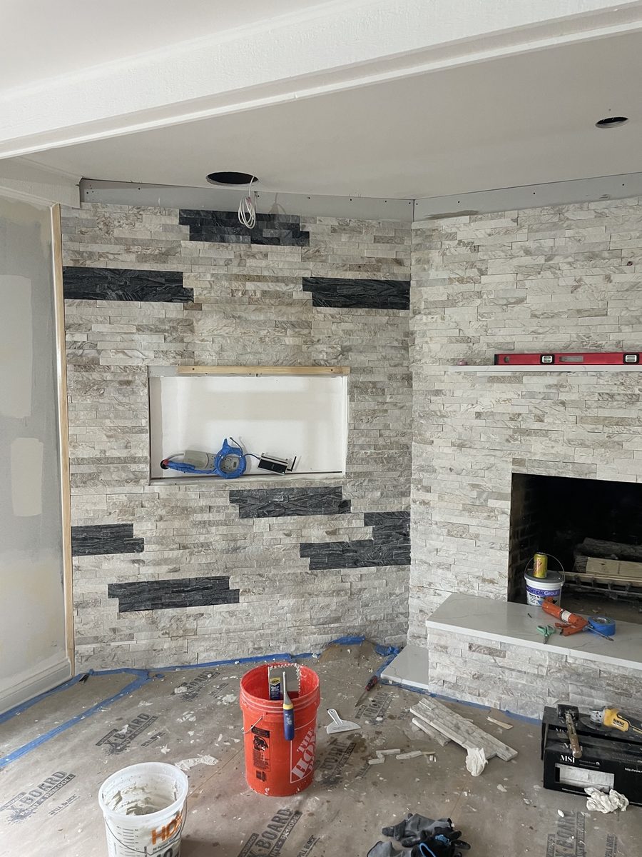 Before: stone fireplace TV feature wall with TV niche under construction