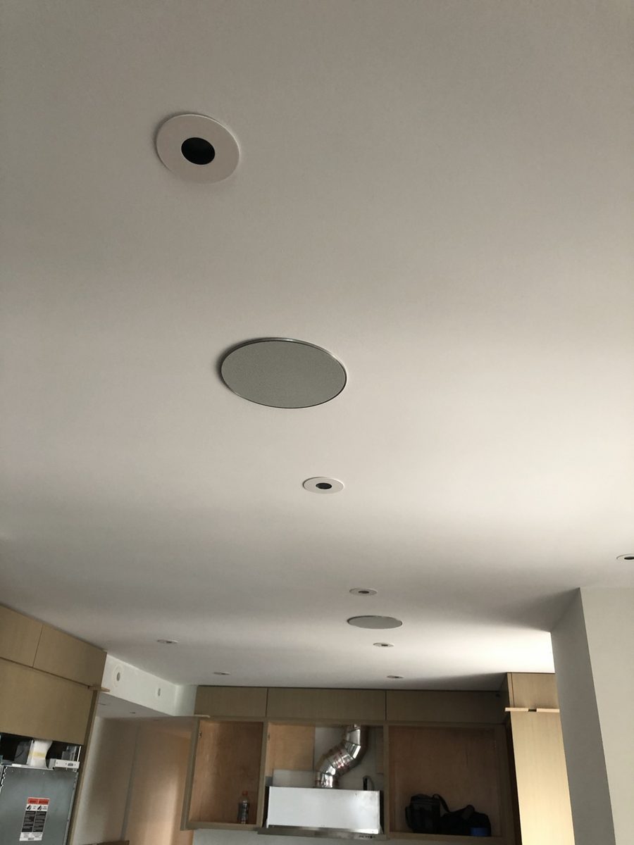 In-ceiling speakers and recessed lighting installed in a ceiling