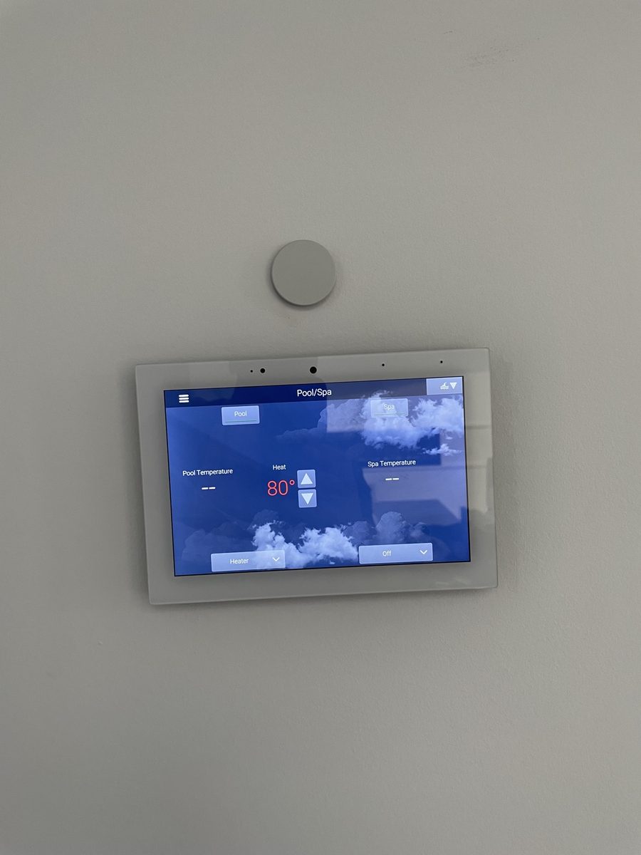 Pool and spa automation touch panel mounted on a wall