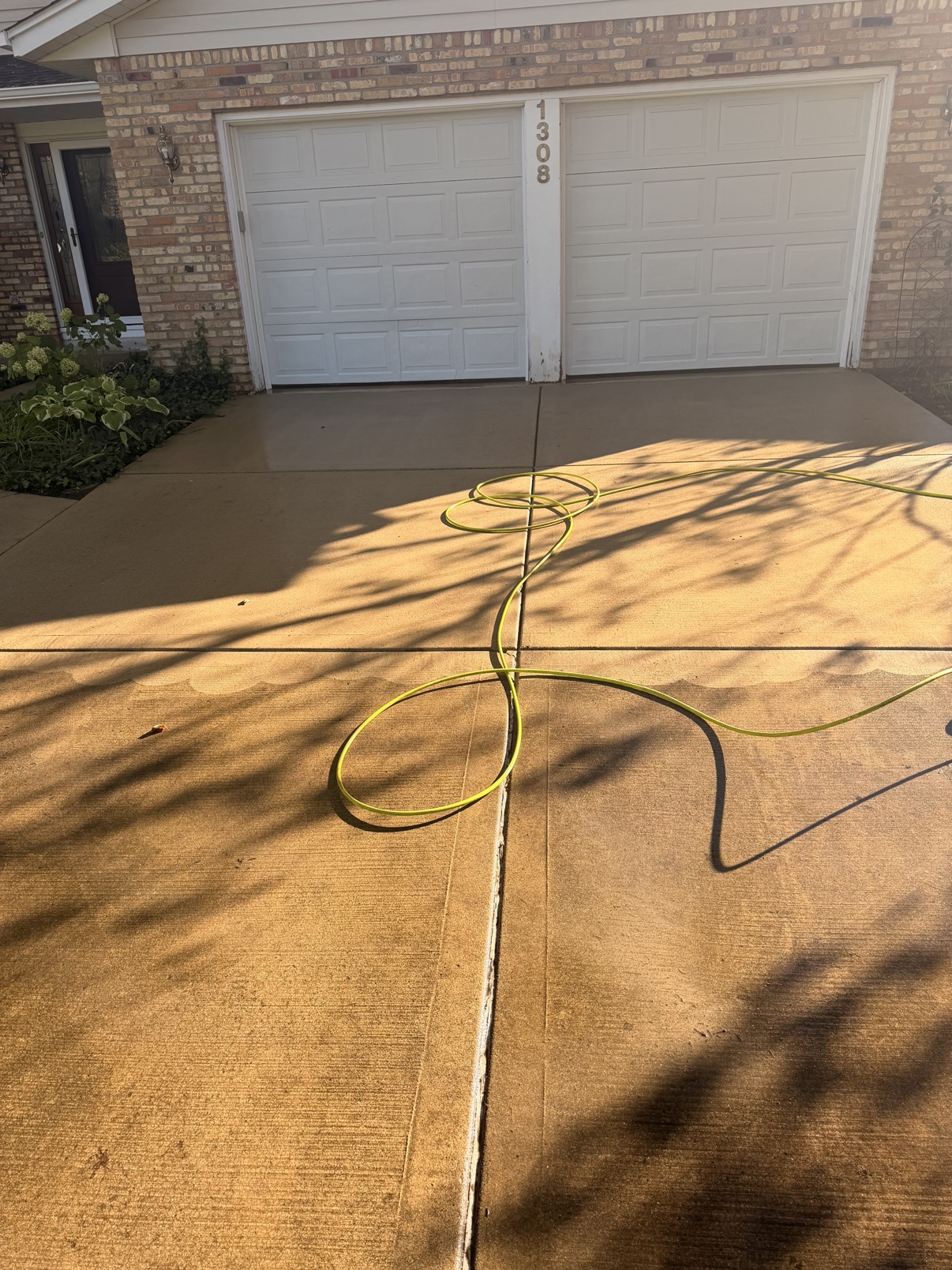 Before: driveway during power washing with hose