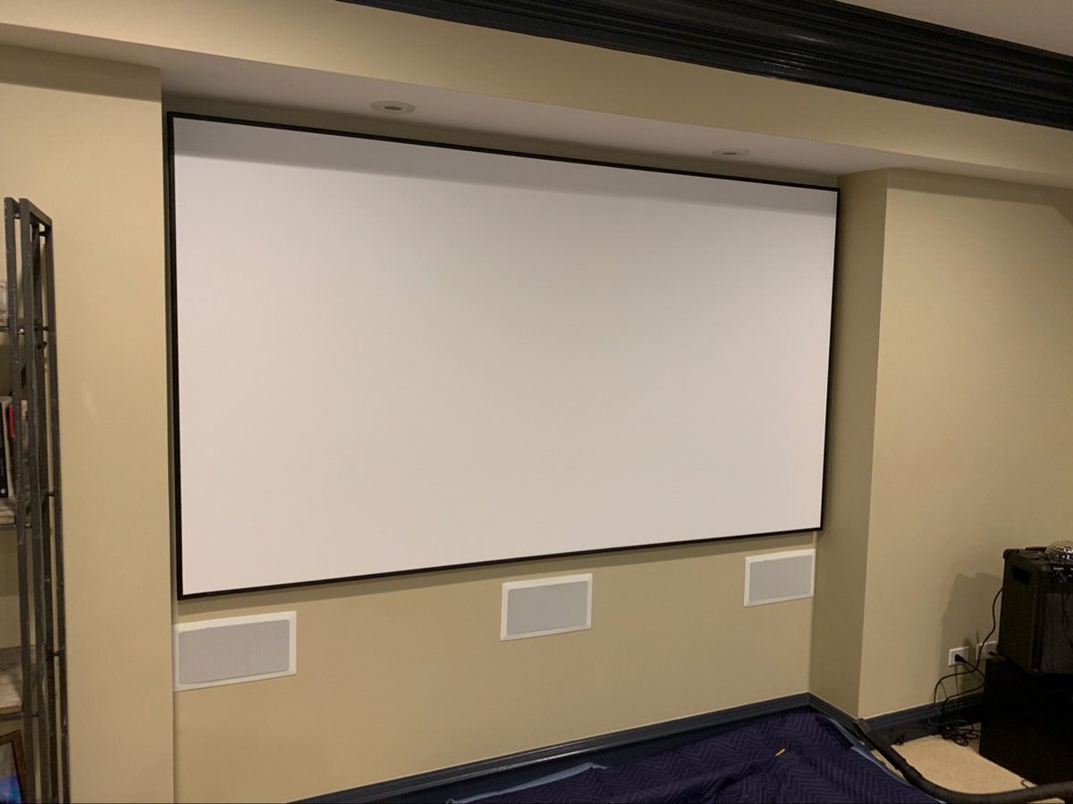 Projection screen with three in-wall speakers mounted below it