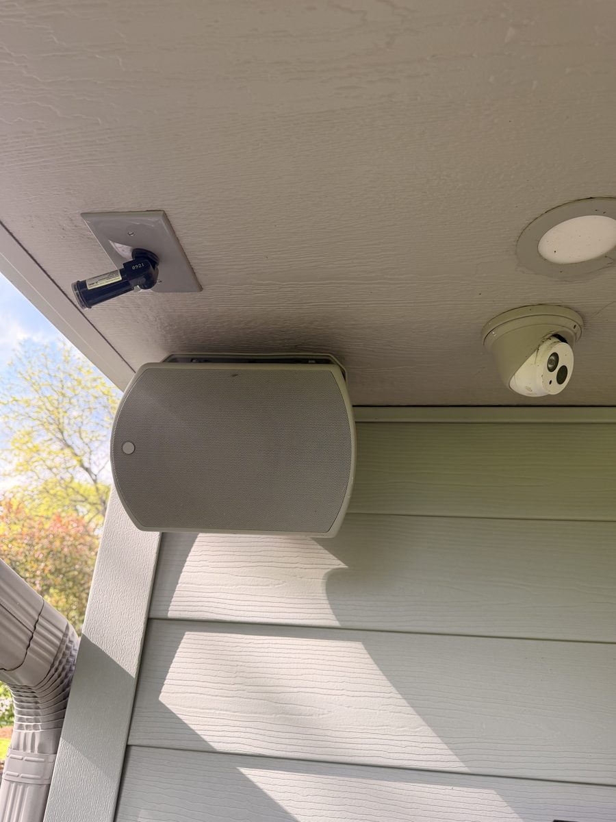 Outdoor speaker and security camera mounted under the eave