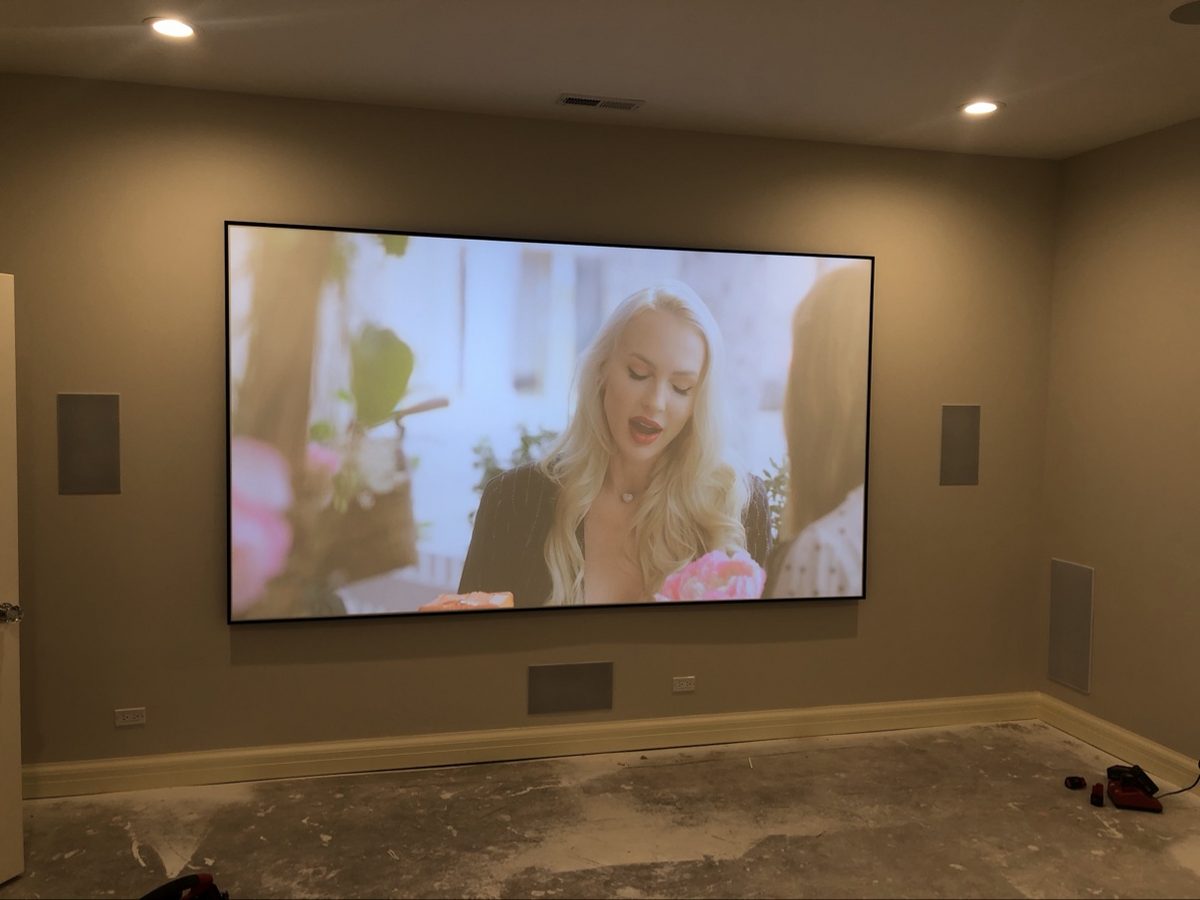 After: finished home theater with a movie playing on the projector screen