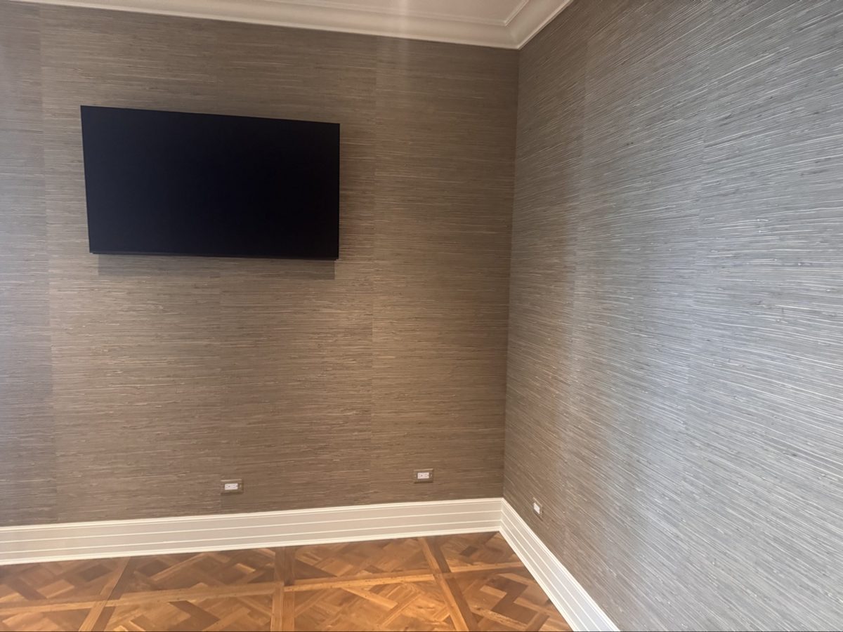 TV mounted on a wall with soundbar