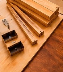 Wooden planks and hardware laid out for furniture assembly